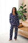 Model standing in front of sofa wearing Women's long sleeve pajama set in Navy Mahjong 

::: Model is 5'5" wearing size M ///
