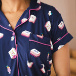 Close up of Women' short sleeve shirt with pocket in Navy Mahjong print with a pink trim