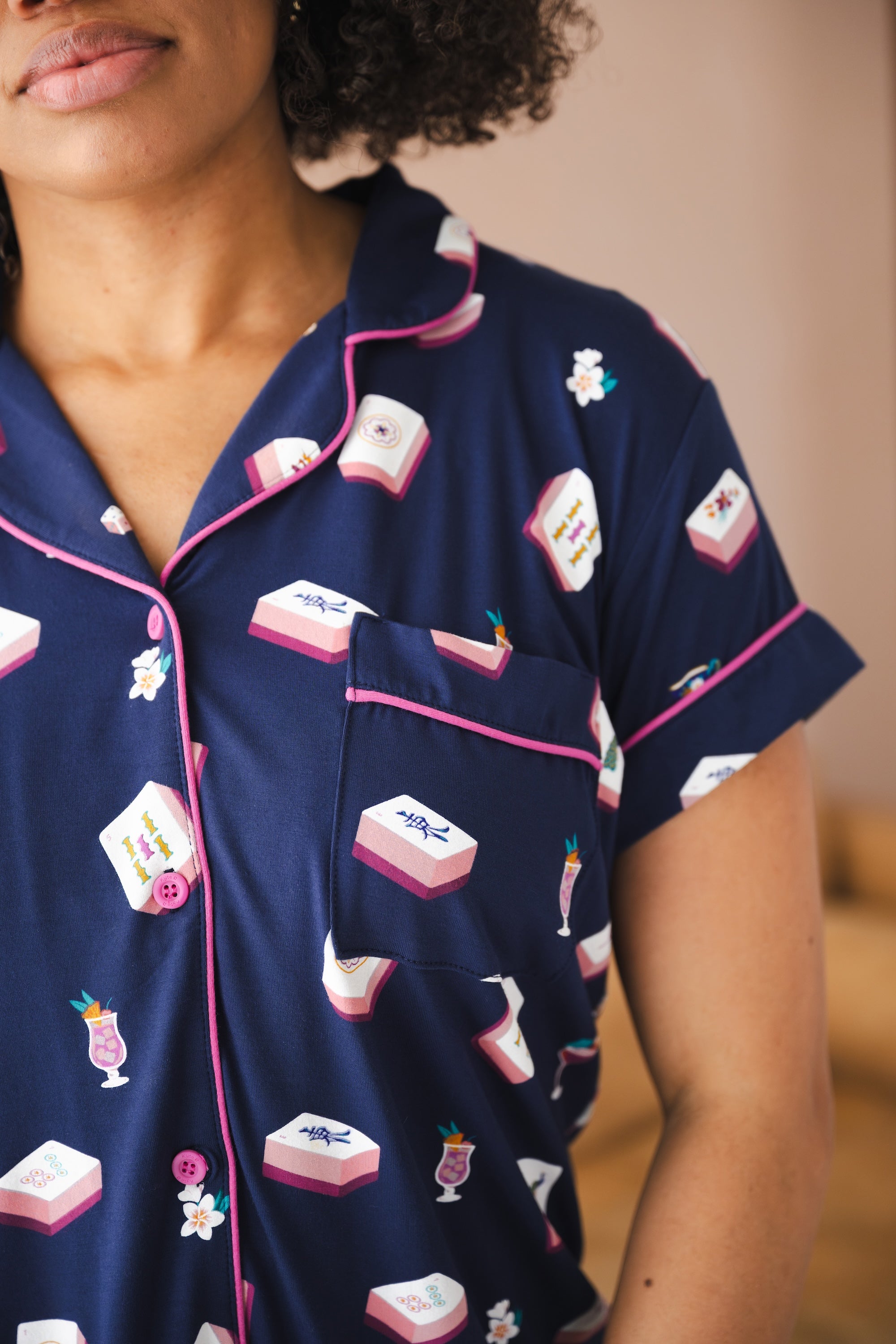 Close up of Women' short sleeve shirt with pocket in Navy Mahjong print with a pink trim