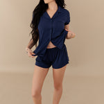Woman modeling Women’s Short Sleeve Pajama Set in Navy with Navy Trim showing buttons