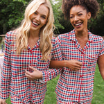 Smiling women with arms hooked modeling the Long Sleeved Women's Pajama Set and Short Sleeved Women's Pajama Set in Patriotic Gingham 