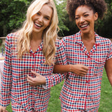 Smiling women with arms hooked modeling the Long Sleeved Women's Pajama Set and Short Sleeved Women's Pajama Set in Patriotic Gingham 