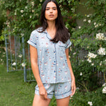 Woman standing in front of greenery and white flowers while modeling the Women's Short Sleeve Pajama Set in Patriotic Goose

::: Model is 5'10" wearing size S ///
