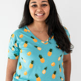 Woman modeling Women’s Relaxed Fit V-Neck in Pineapple close up on print