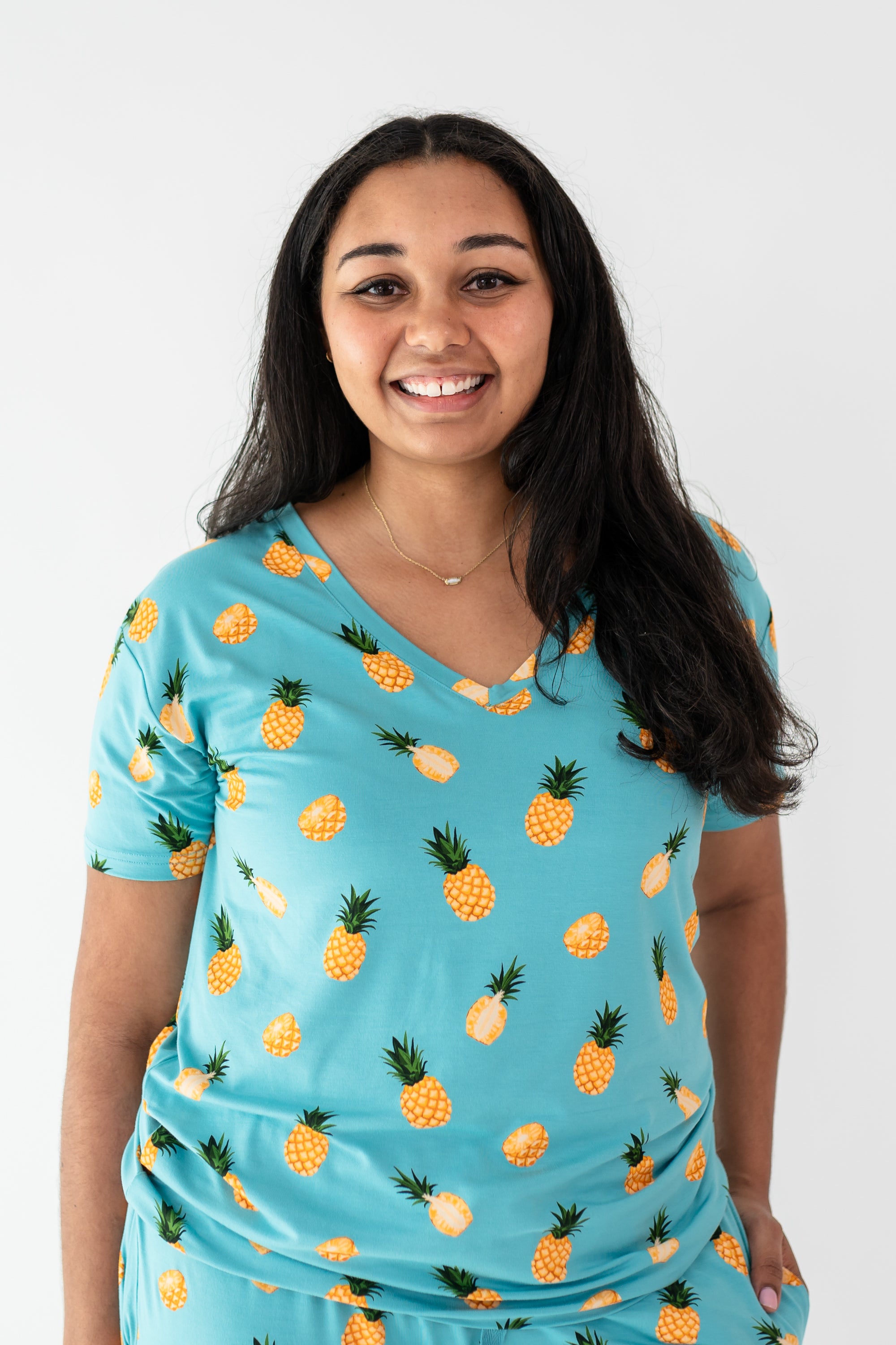 Woman modeling Women’s Relaxed Fit V-Neck in Pineapple close up on print