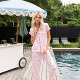 Model posing near pool side wearing Women's Short Sleeve Cropped Pajama Set in Sakura Ice Cream

::: Model is 5'11" wearing size S ///