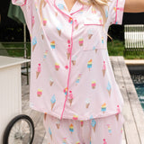 Close up of the top from the Women's Short Sleeve Cropped Pajama Set in Sakura Ice Cream by a pool side