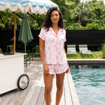 Model wearing Women's Short Sleeve Pajama Set in Sakura Ice Cream by a pool side