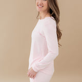 Woman modeling Women's Jogger Pajama Set in Sakura showing sides of pajama with pockets