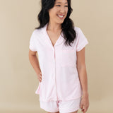 Woman modeling Women’s Short Sleeve Pajama Set in Sakura with Cloud Trim looking off to side
