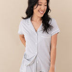 Woman smiling wearing Women’s Short Sleeve Pajama Set in Storm with Cloud Trim