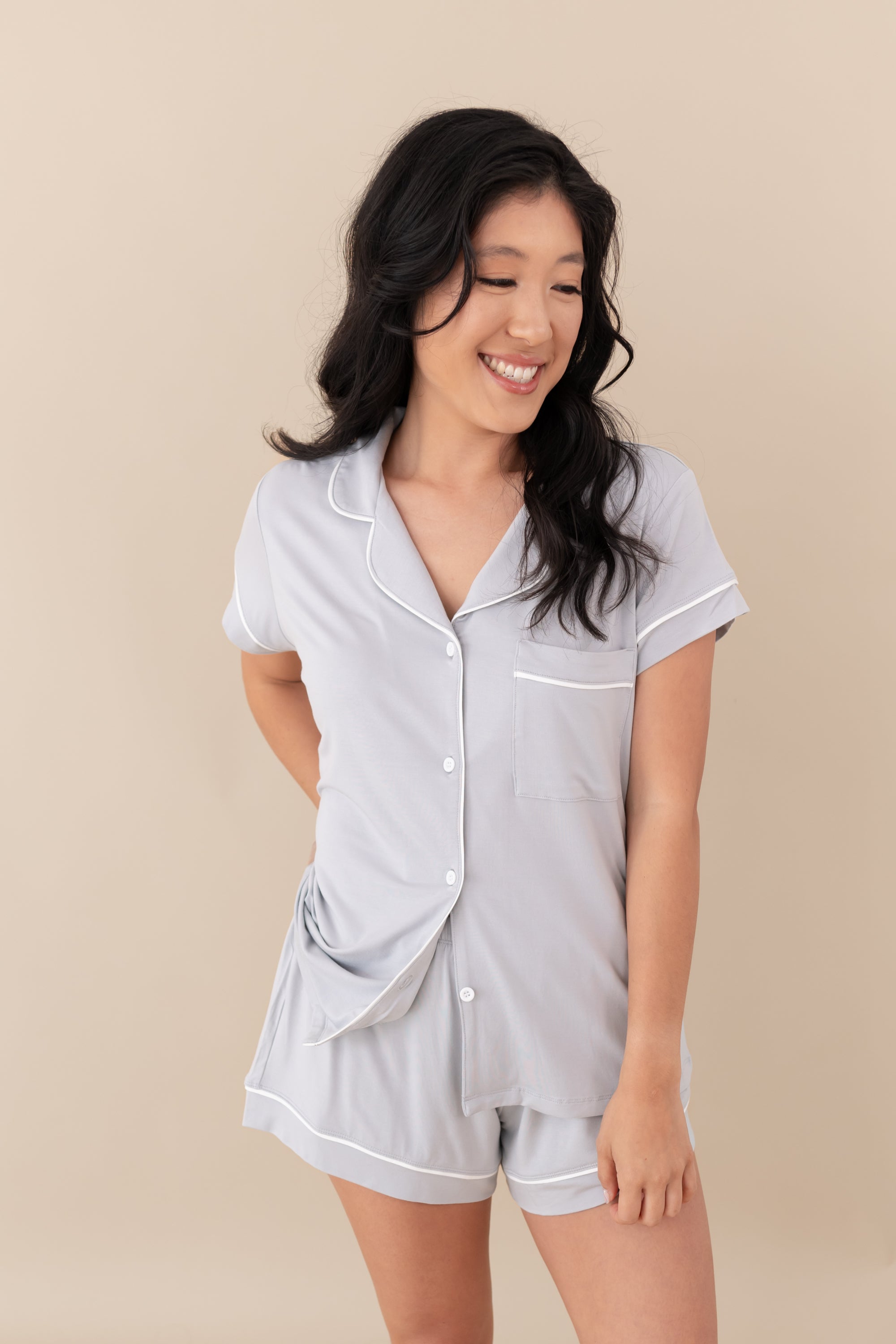 Woman smiling wearing Women’s Short Sleeve Pajama Set in Storm with Cloud Trim