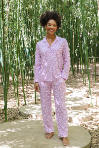 Model smiling in Women's Long Sleeve Pajama Set in Thistle Leopard print