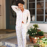Woman in a white tulip pajama set standing on a porch with potted plants. ::: Model is 5'9"" wearing size S ///