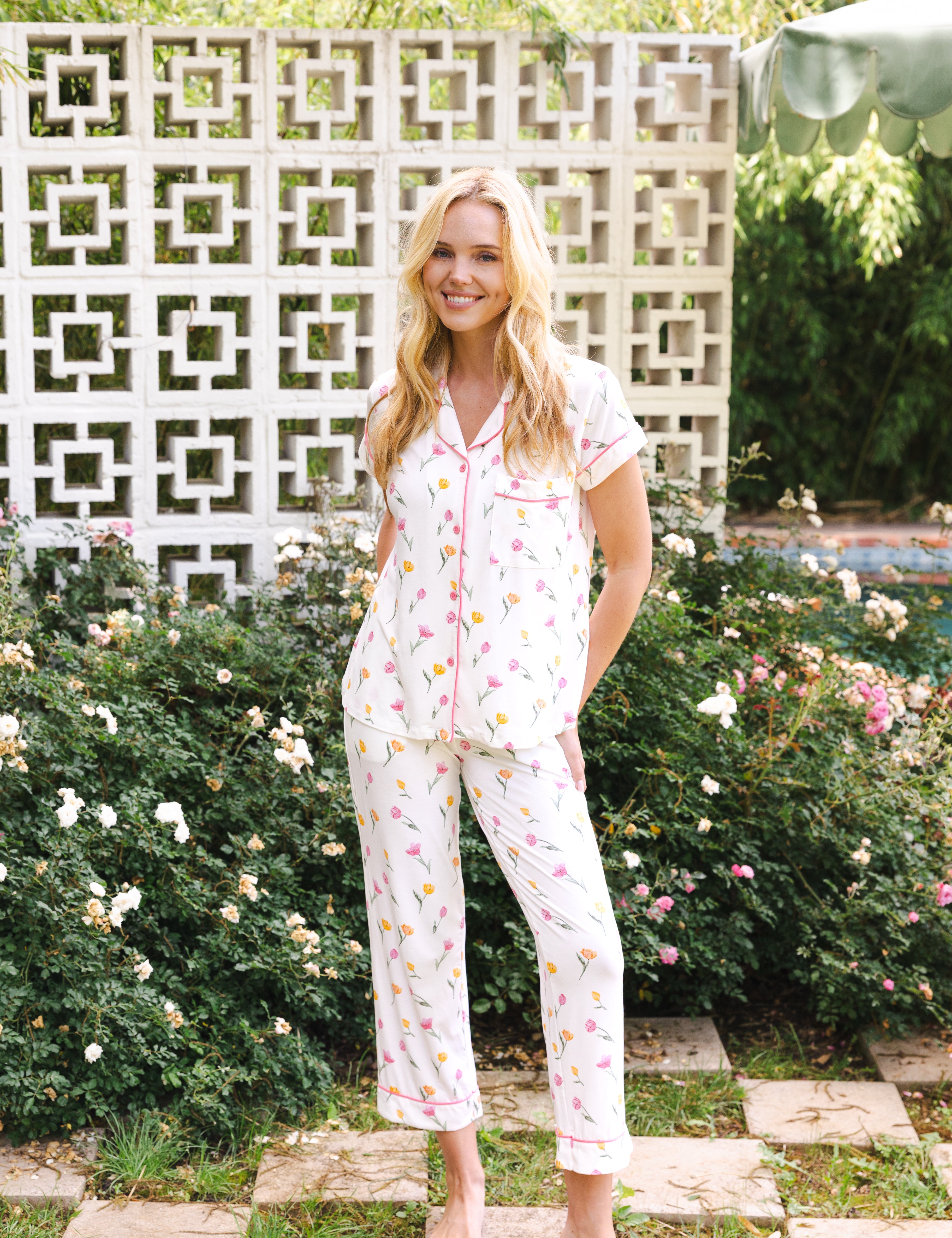 Woman wearing a tulip pajama set standing in a garden. ::: Model is 5'9" wearing size XS ///