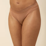 Brown underwear worn by a person on a beige background