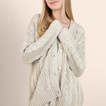Woman modeling oat colored cable knit cardigan over a silk dress  ::: Model is 5'7" wearing size S ///