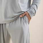 Light gray long-sleeve top and pants set on a beige background
