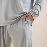 Light gray long-sleeve top and pants set on a beige background