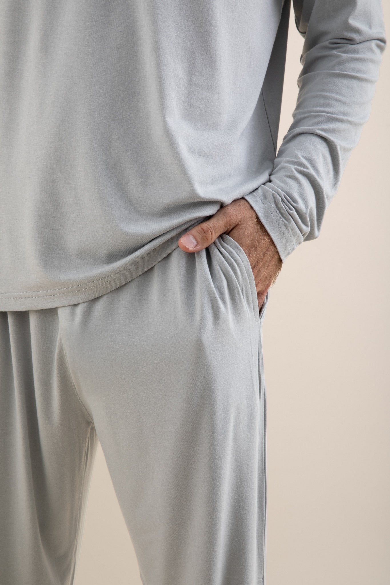 Light gray long-sleeve top and pants set on a beige background