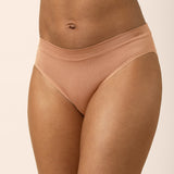 Bra and panties set in a tan color on a beige background