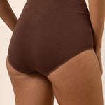 Brown high-waisted underwear on a beige background