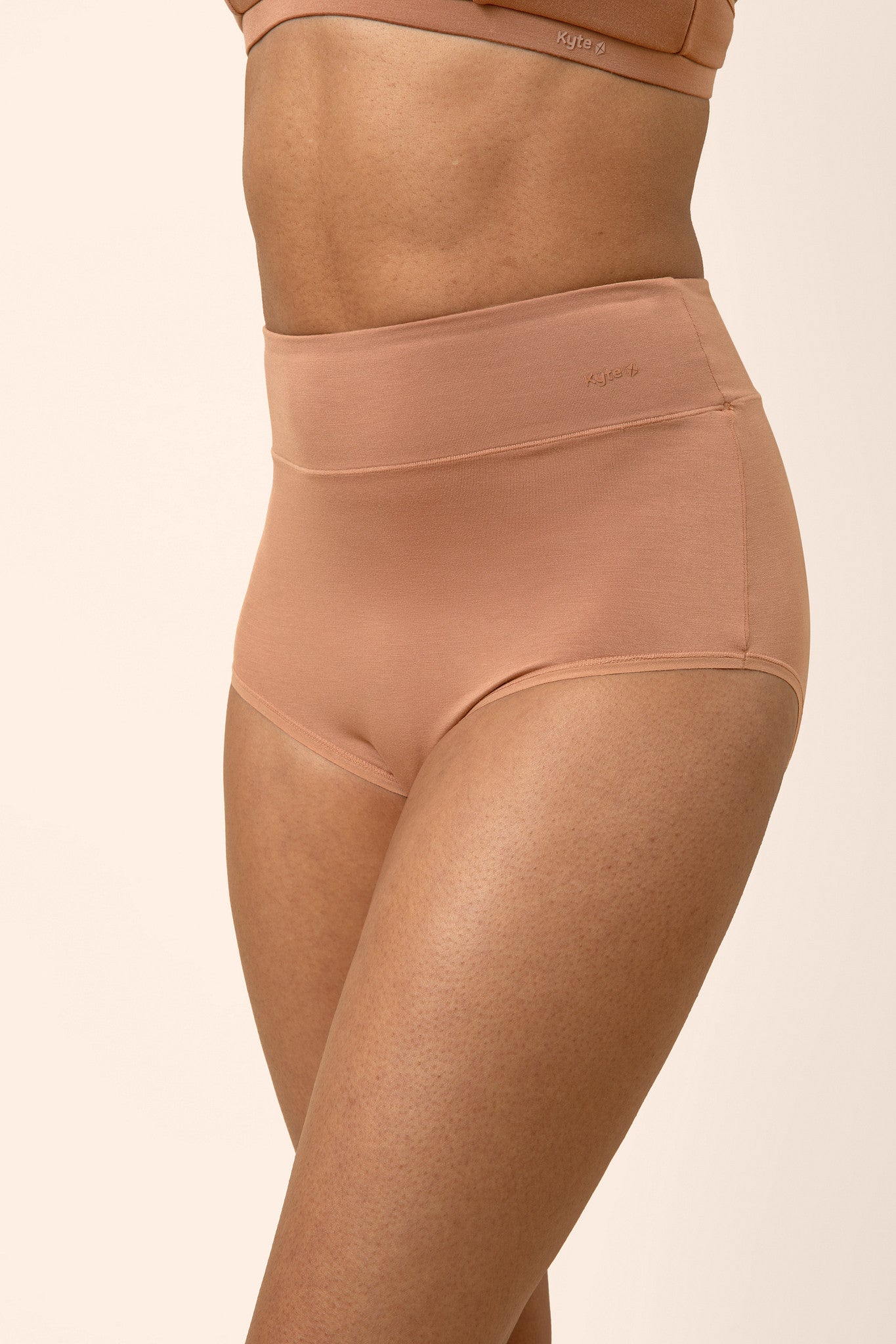 Tan high-waisted underwear on a beige background