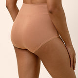 Back of tan high-waisted underwear on a beige background