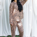 Women modeling the Long Sleeve Pajama Set in Latte Leopard with one  hand in her hair