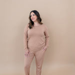 Woman looking to the side while modeling the Kyte Women's Jogger Set in Latte