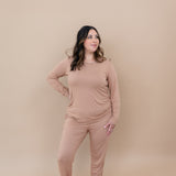 Model with hand on her hip while wearing the  Kyte Women's Jogger Set in Latte
