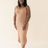 Smiling female wearing the Women's Ribbed Cami Dress in Latte with both hands on thighs