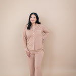 Smiling woman with hand on her hip while wearing the Long Sleeve Pajama Set in Latte