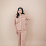 Smiling woman with hand on her hip while wearing the Long Sleeve Pajama Set in Latte