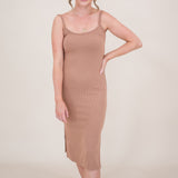 Smiling model with hand on her hip while wearing the Kyte Ribbed Cami Dress in Latte