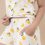 Close up showing the pocket and elastic waistband on the shorts in the Women’s Tank Set in Lemon