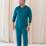 Male model wearing the Men's Lounge Pants in Loch paired with the Loch Men's Long Sleeve Henley Top