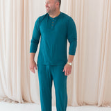 Male model wearing the Men's Lounge Pants in Loch paired with the Loch Men's Long Sleeve Henley Top