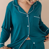 Close up of button closure and fabric om Women's Long Sleeve Pajama Set in Loch with Cloud Trim