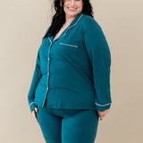 Female modeling Kyte Baby's Women's Long Sleeve Pajama Set in Loch with Cloud Trim