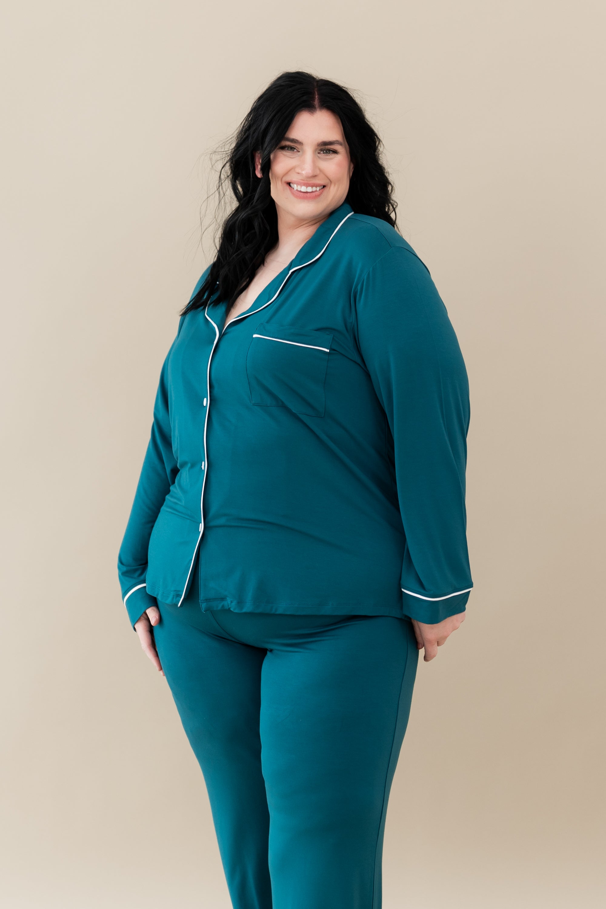 Female modeling Kyte Baby's Women's Long Sleeve Pajama Set in Loch with Cloud Trim
