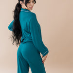 Female modeling the back of Women's Long Sleeve Pajama Set in Loch with Cloud Trim