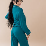 Female modeling the back of Women's Long Sleeve Pajama Set in Loch with Cloud Trim
