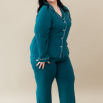 Smiling female wearing Women's Long Sleeve Pajama Set in Loch with Cloud Trim