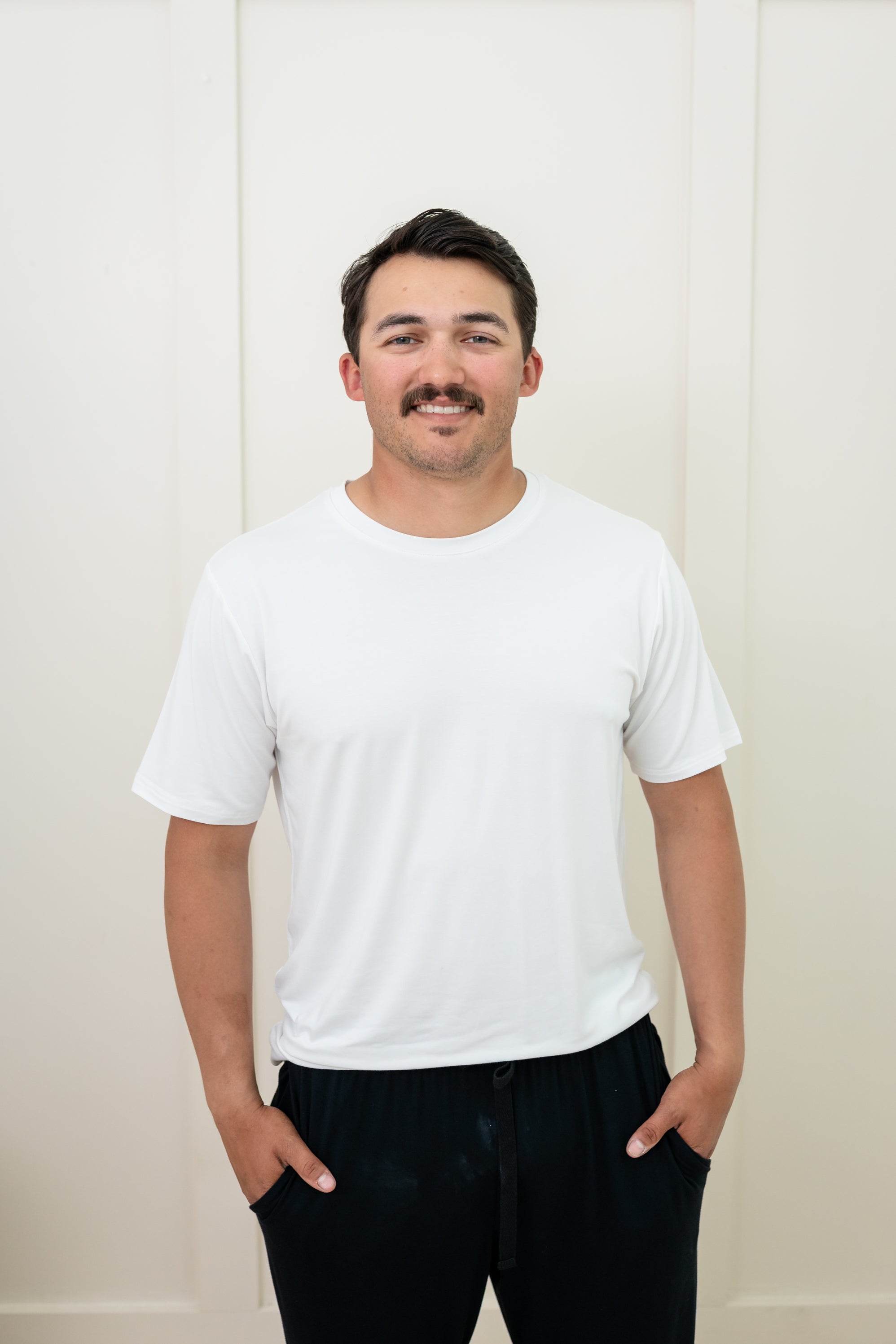 Man modeling Men's Crew Neck Tee in Snow and Midnight Lounge Pants