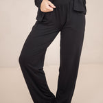 The pants of the Long-Sleeved Women's Pajama Set in Midnight with Midnight Trim shown on a model 