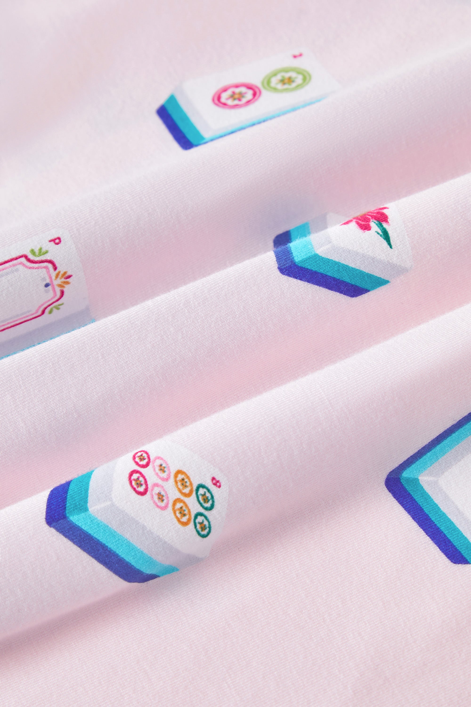 Close up of Mahjong print on Pink Fabric