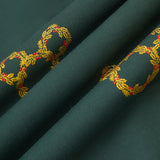 An all-over print of Mickey Mouse-shaped Christmas wreaths with gold and olive-green leaves and red holly berries, over a very dark green background color