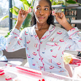 Woman in a home setting wearing a mahjong patterned pajama 