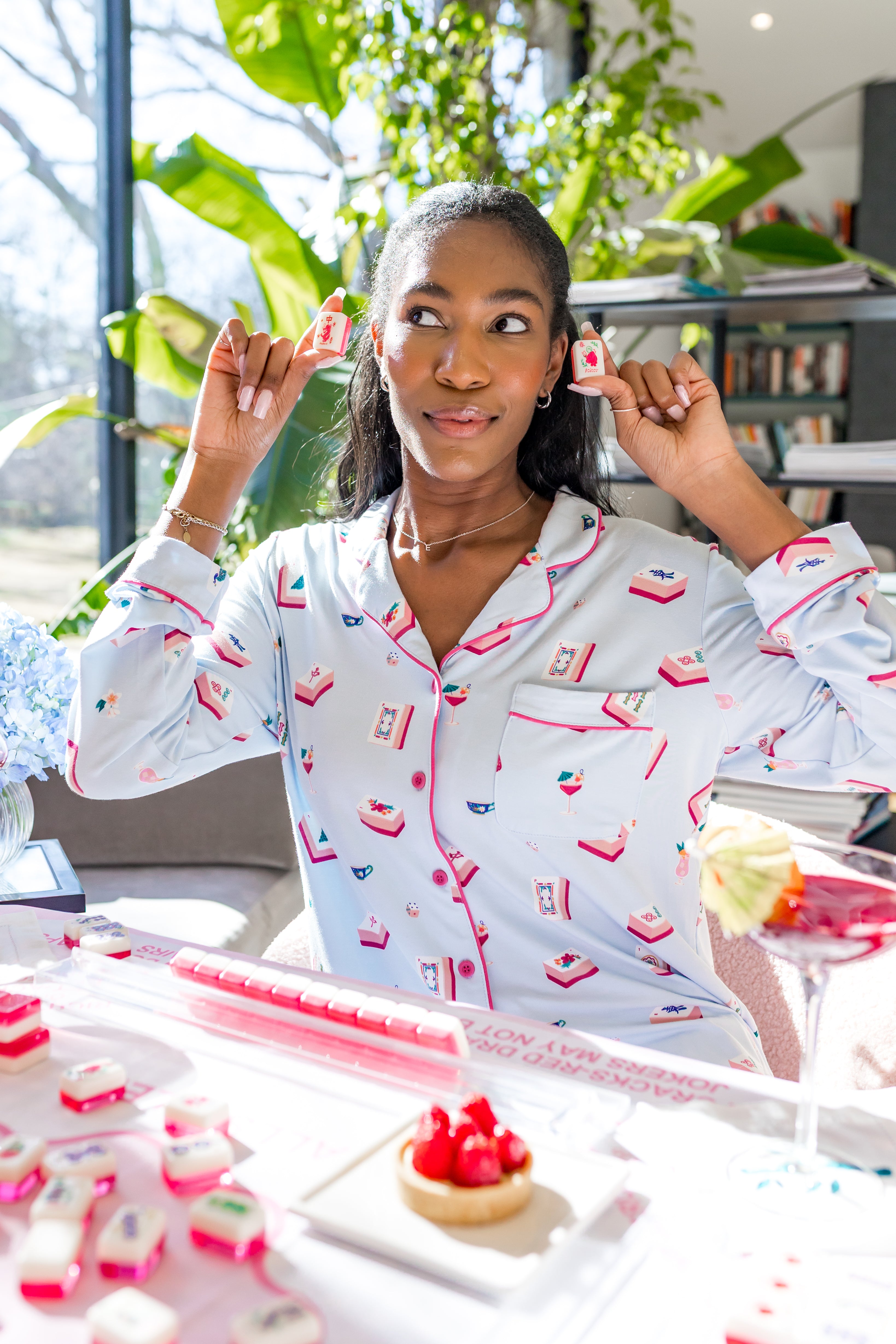 Woman in a home setting wearing a mahjong patterned pajama 